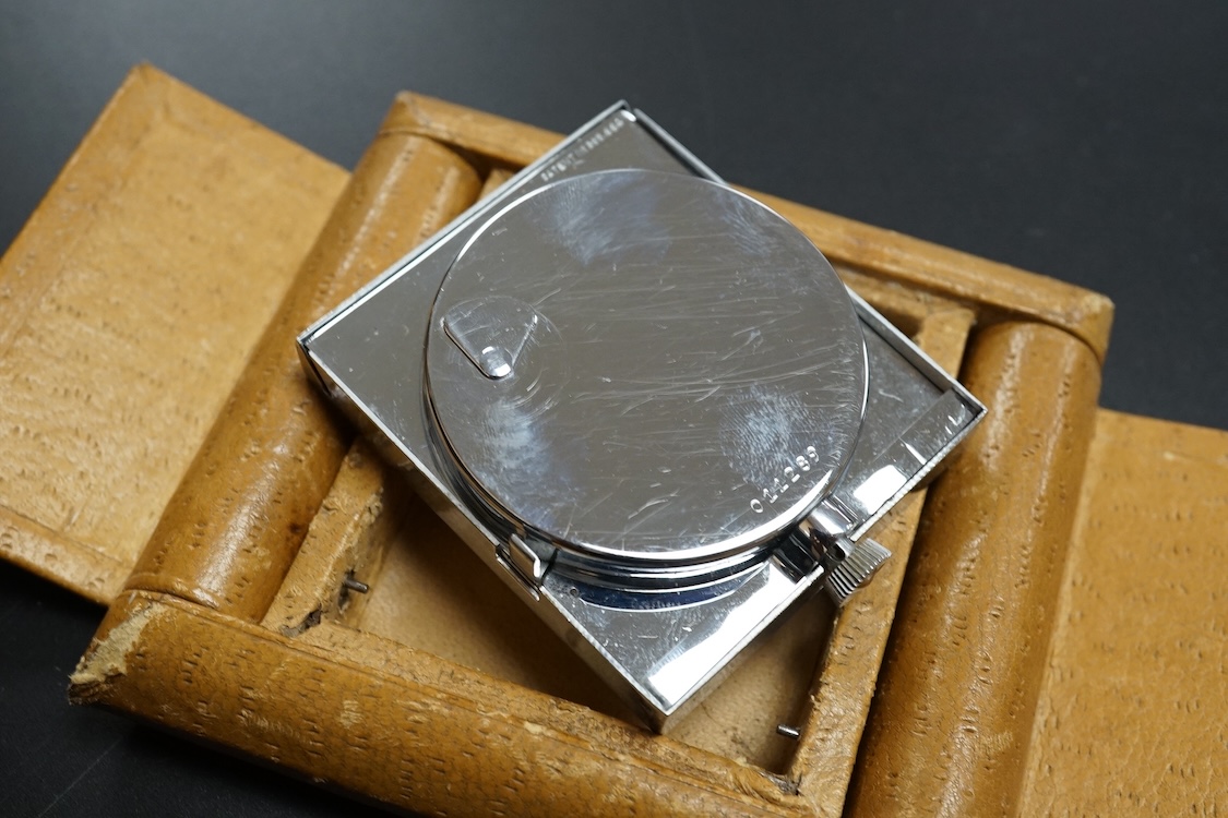 A leather cased chrome LeCoultre 8-day travelling timepiece, 9.5cm wide